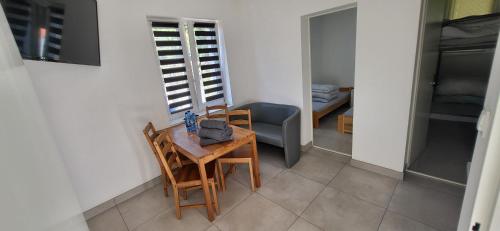 a dining room with a table and chairs and a room at Noclegi Tuszyn M in Tuszyn