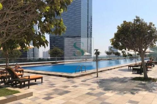 a swimming pool in the middle of a city at Reem Island 2BHK LUXURY APARTMENT! in Abu Dhabi
