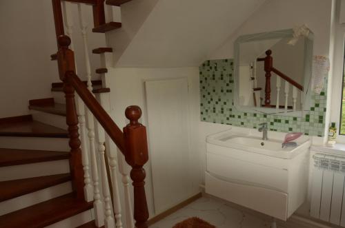 a bathroom with a sink and a staircase at Life House in Bol'shevik