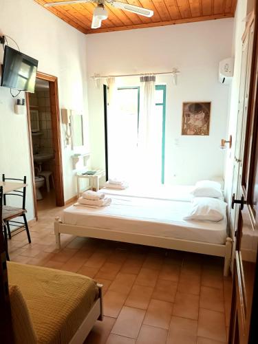 a large bed in a room with a window at Skardamoula's Studios n Apartments in Kardamili