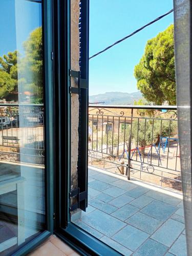 a view from a window of a balcony at Skardamoula's Studios n Apartments in Kardamili