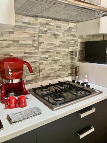 a kitchen with a red mixer and a stove top at Casa Ulivo San Sperate in San Sperate