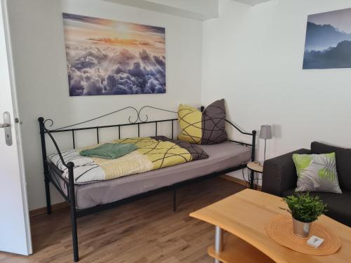 a bed in a living room with a couch at Ferienwohnung im Herzen Wernes in Werne an der Lippe