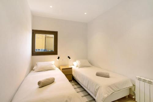 two beds in a small room with a mirror at Casa en Parque Nacional del Teide in Las Canadas del Teidn