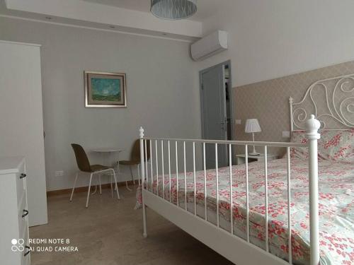 a bedroom with a bed and a table and a chair at Nuovi bilocali Panta Rei - Suite della Terra in Senigallia