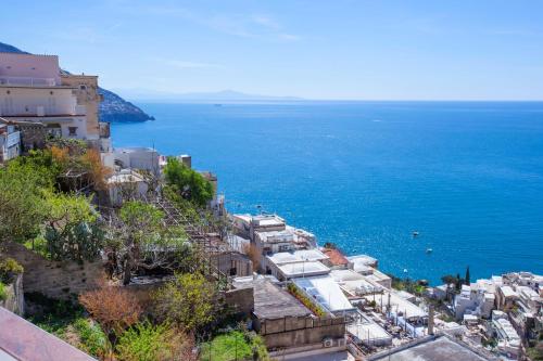 a group of buildings on a hill next to the ocean at Estate4home - Casa Darly in Positano