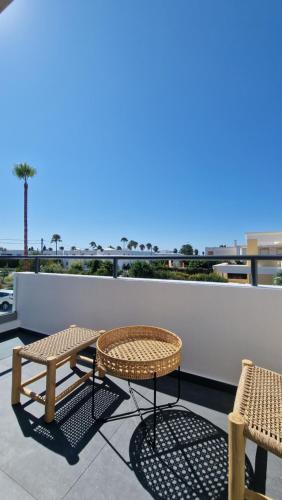 two chairs and a table on the roof of a building at RASTONI VILLAS BY AEGEAN HOUSES in Psalidi