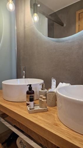 a bathroom with a white sink and a mirror at RASTONI VILLAS BY AEGEAN HOUSES in Psalidi