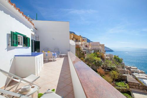 a balcony with chairs and a view of the ocean at Estate4home - Casa Darly in Positano