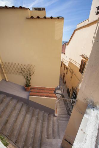 a stairway with a bench on the side of a building at Estate4home - Casa Darly in Positano