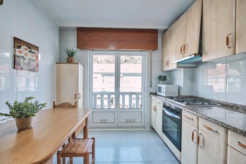 a kitchen with a counter and a stove top oven at Peregrina Pensión 5 in O Pedrouzo