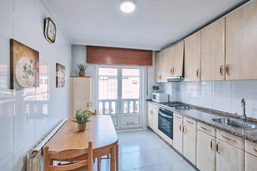 a kitchen with a sink and a counter top at Peregrina Pensión 5 in O Pedrouzo