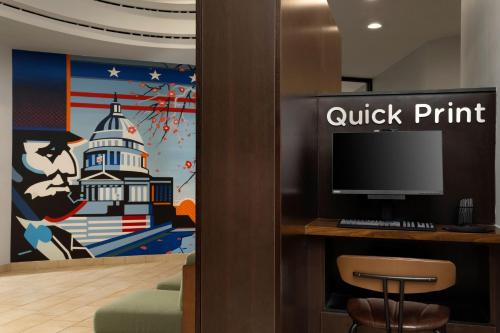 a lobby with a wall with a painting of a lighthouse at Courtyard by Marriott Washington Capitol Hill/Navy Yard in Washington
