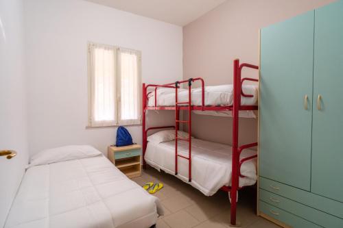 a bedroom with two bunk beds and a window at Stork Family Camping Village in Giulianova