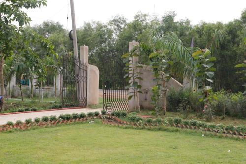 a cemetery with a gate and some plants at Geetanjali in Bolpur