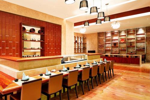 a dining room with a long table and chairs at Sheraton Jinan Hotel in Jinan