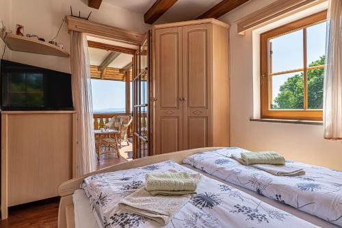 a bedroom with two beds and a balcony at Vineyard Cottage Stepan - Happy Rentals in Črnomelj