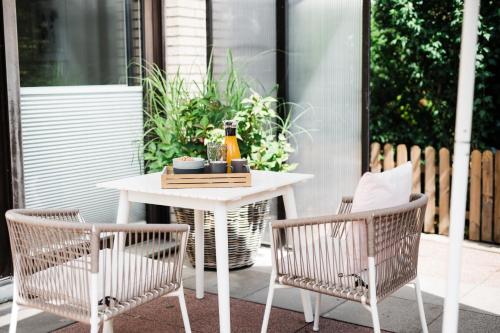 een witte tafel en 2 stoelen op een patio bij Ferienwohnung Salinchen in Bad Rothenfelde