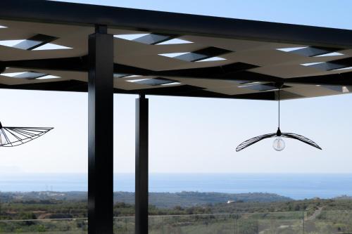 a glass window with a view of the countryside at Caelum Villa, By Hellocrete in Píkris