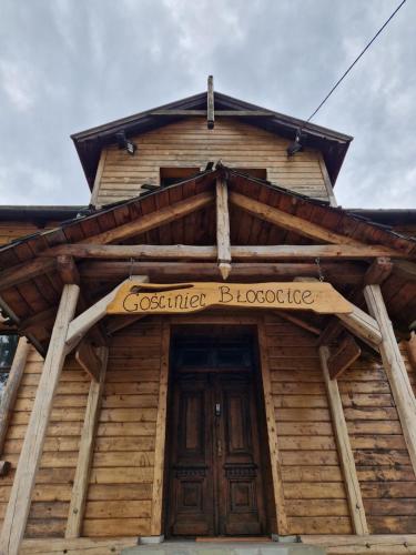 a sign on the front of a wooden building at Gościniec Błogocice in Cieszyn