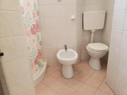 a bathroom with a toilet and a bidet at Casa di Adele in Anzio