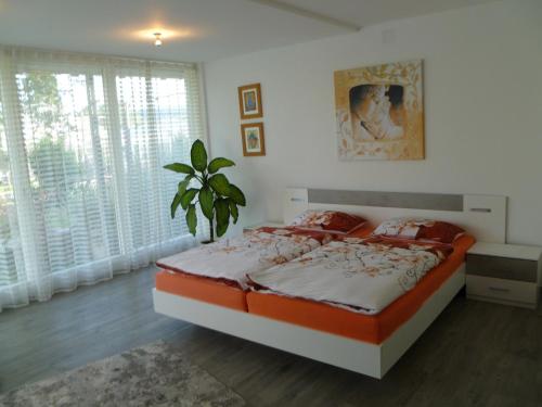 um quarto com uma cama e uma planta em Villa Xadayu em Reichenau
