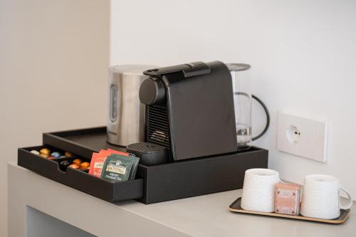 a coffeemaker sitting on top of a kitchen counter at Riviera Suites in Civitavecchia