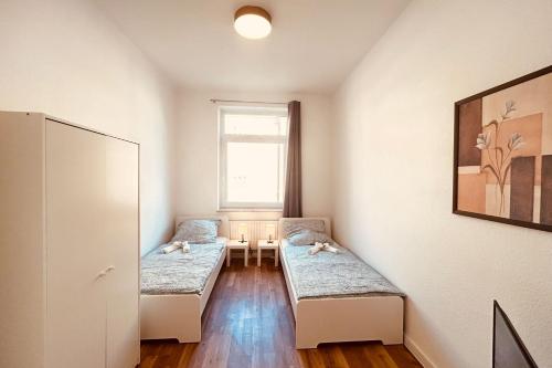 a room with two beds in it with a window at Work & Stay Apartment with Balcony in Bremerhaven in Bremerhaven