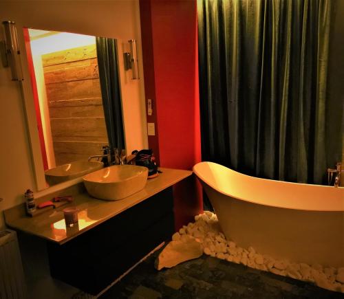 a bathroom with two sinks and a tub and a mirror at NETFLIX & CHILL in Remetea Mare