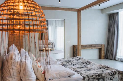 Dormitorio con cama y lámpara de araña grande en Verhovel Hotel, en Verkhovyna