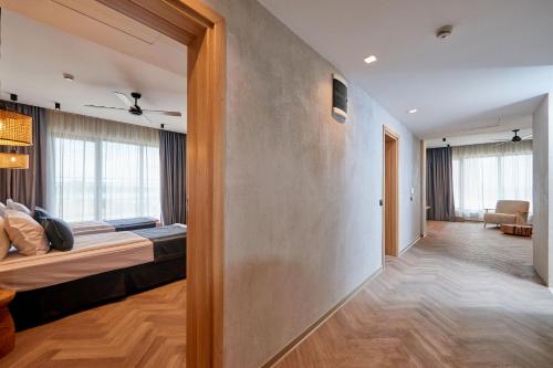 a hotel room with a bed and a hallway at Hotel Fara - Marina Cape in Aheloy