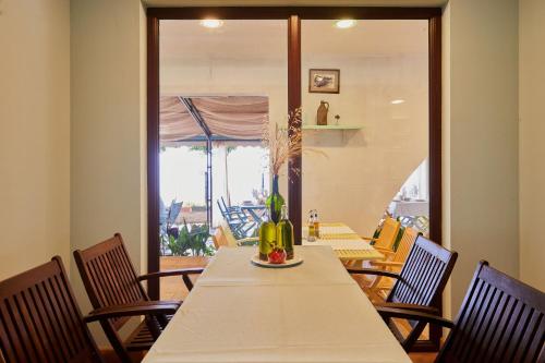 a dining room with a table with chairs and a window at Hotel Fara - Marina Cape in Aheloy