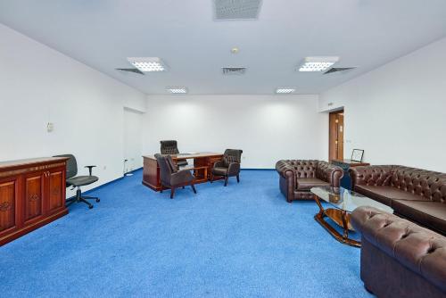 a large room with couches and chairs and a desk at Hotel Fara - Marina Cape in Aheloy