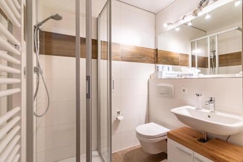 a bathroom with a shower and a sink and a toilet at Landhaus Laih in Grafenau