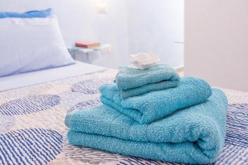 una pila de toallas sentadas encima de una cama en Su Nidu Nou, en Dorgali
