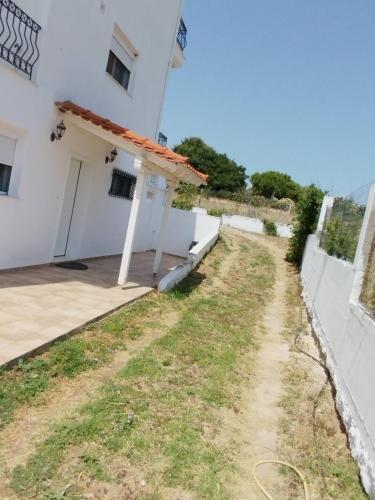 a view of a white building with a porch at Summer and Winter Villas in Néa Tríglia