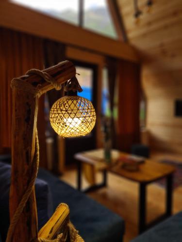 a light hanging from a wooden pole in a room at Trip Zone Kazbegi in Kazbegi