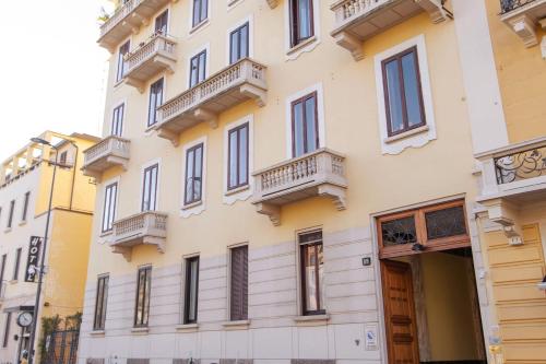 a building with balconies on the side of it at Liberty Home in Milan
