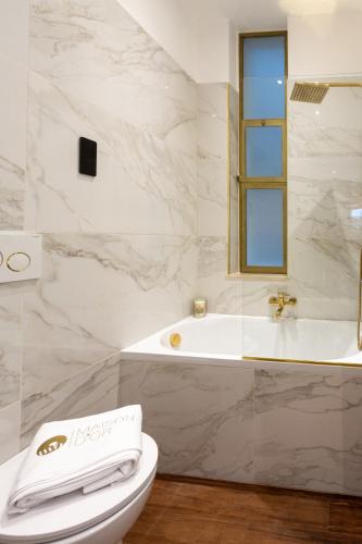 a bathroom with a toilet and a bath tub at Maison d'Or in Genova