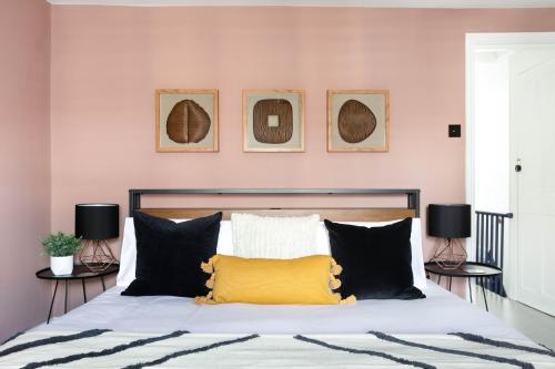 a bedroom with a bed with black and white pillows at The Pride in Worthing