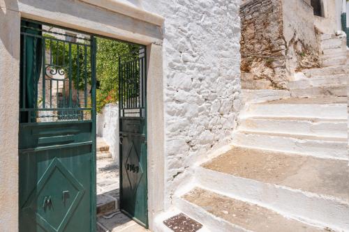 an entrance to a building with a green door at Zeus House in Philotium