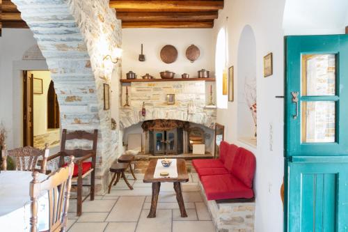 a living room with a fireplace and a red couch at Zeus House in Philotium