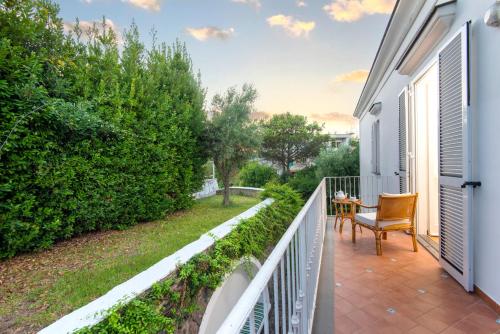 a balcony with a table and a chair on it at Il Lauro Luxury Villa in Ischia