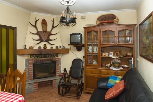 a living room with a couch and a fireplace at Apartamentos rurales La Veiga in La Riera