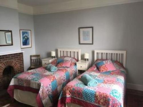 two beds sitting next to each other in a bedroom at The Highlands - Nr Rye - Tennis Court in Iden