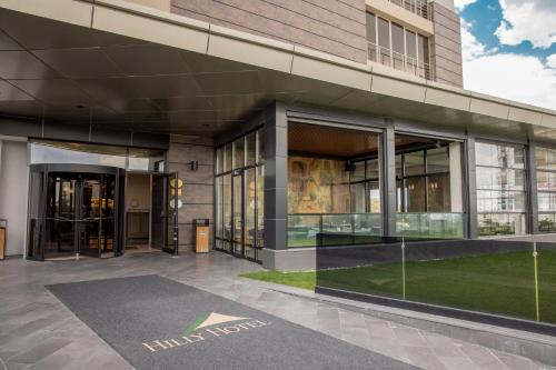 an external view of a building with glass doors at Hilly Hotel in Edirne