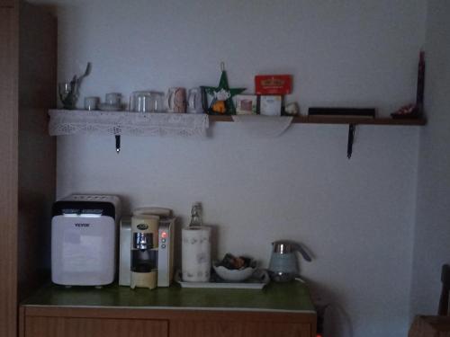 a kitchen with a counter with a coffee maker on it at Affittacamere Cooperativa Olistica in Mamoiada