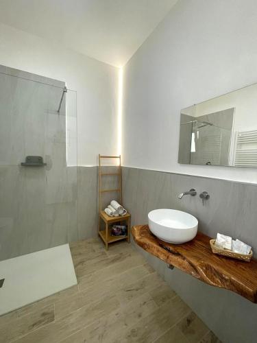 a bathroom with a sink and a mirror at Le Fronde Vieste in Vieste
