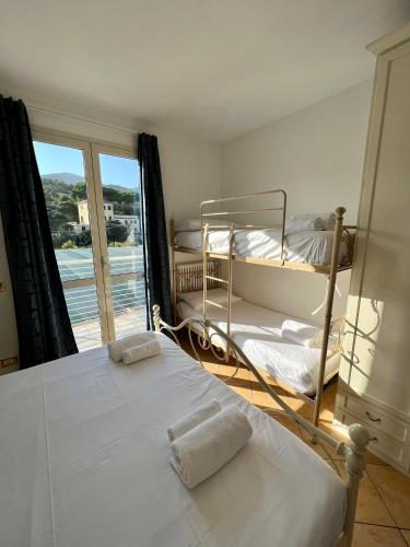 a bedroom with two bunk beds and a view of the ocean at Casa Anselmo in Loano