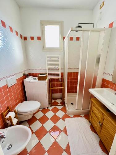 a bathroom with a toilet and a shower and a sink at Casa Anselmo in Loano